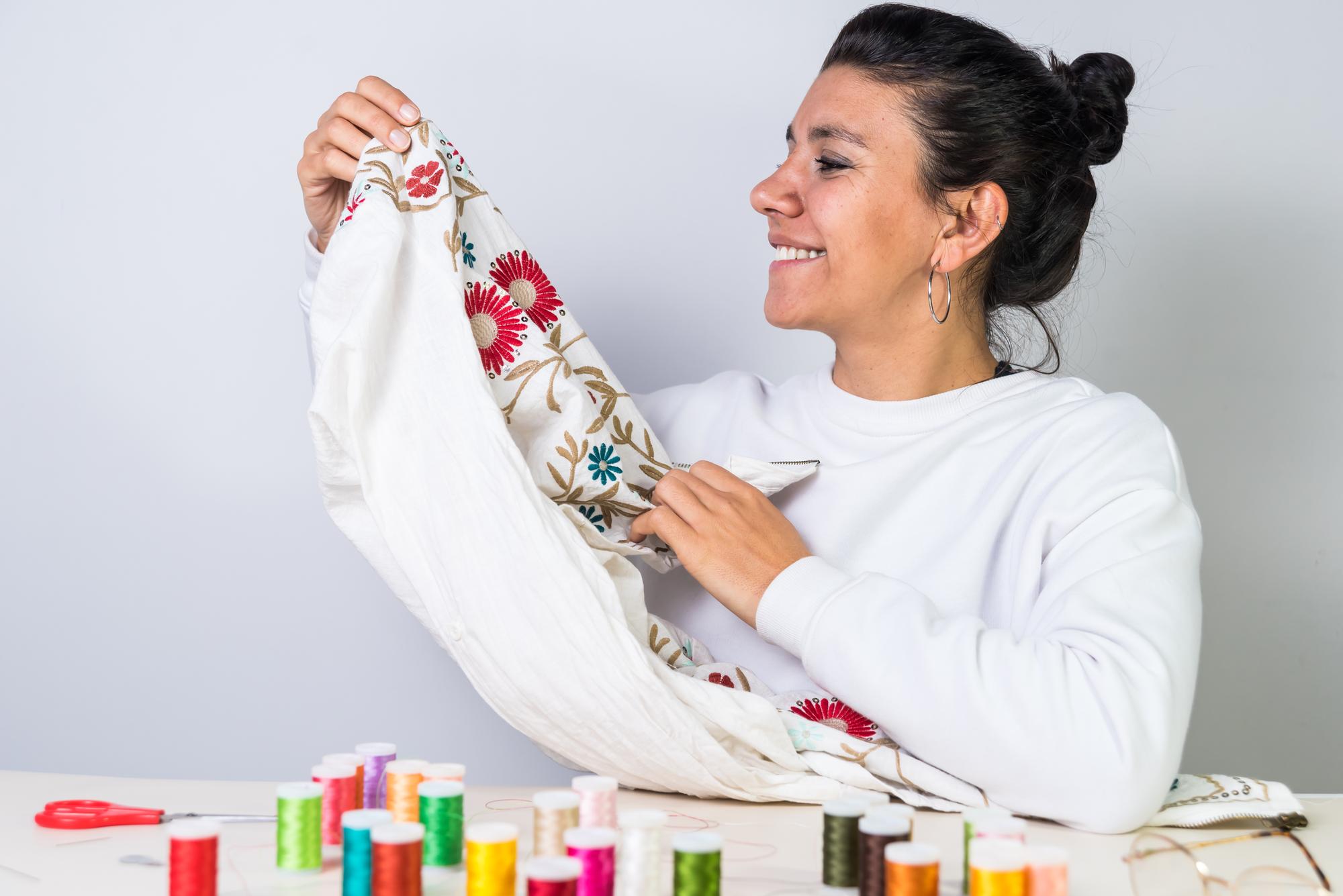 Artist holding embroidered cloth